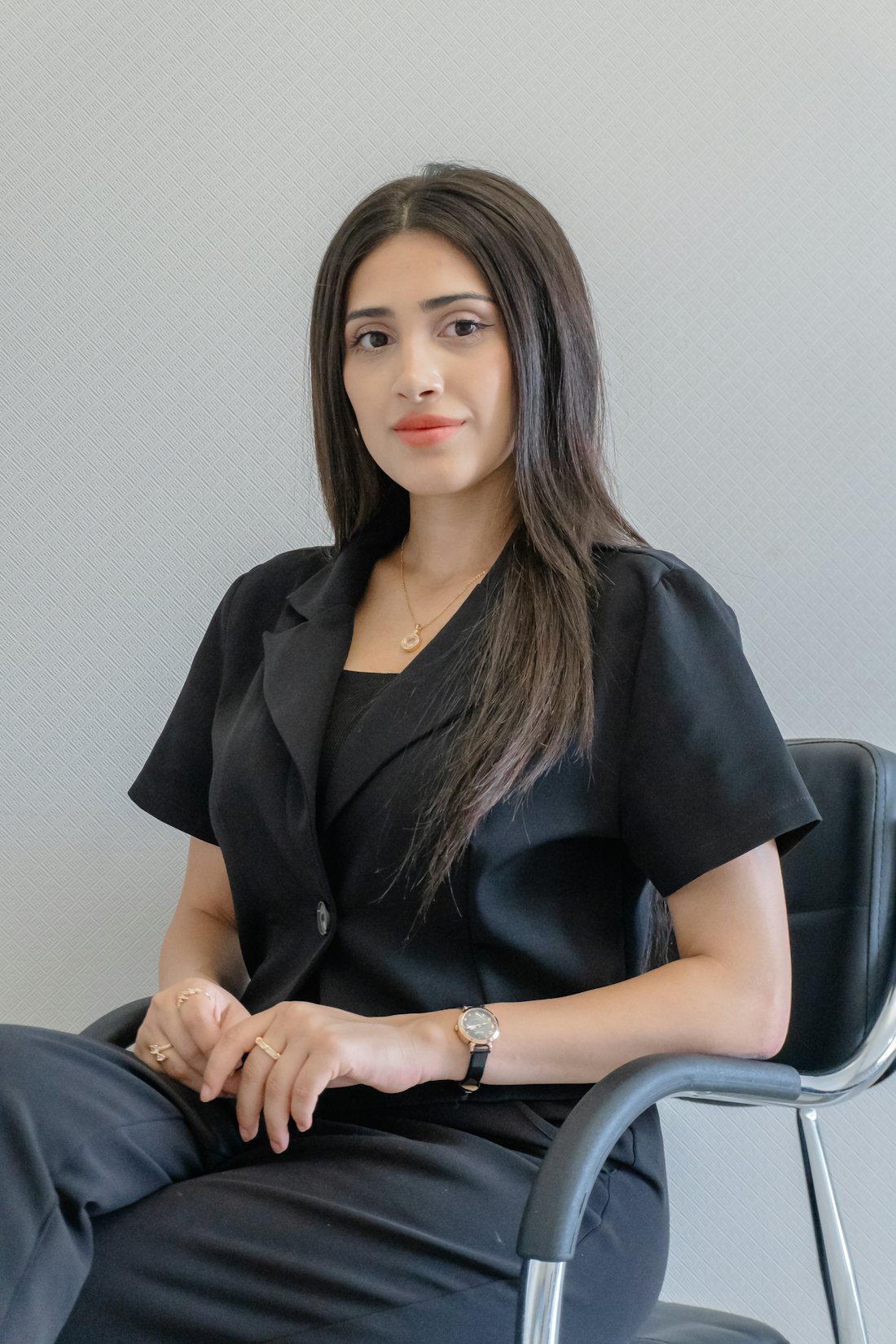 An adviser in an office, seated, looking at the camera